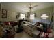 View of a bedroom with a ceiling fan, wood paneling, and floral curtains at 506 Hearne Farm Rd, Mount Gilead, NC 27306