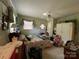 View of a bedroom with a ceiling fan, wood paneling, and floral curtains at 506 Hearne Farm Rd, Mount Gilead, NC 27306