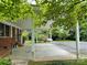 Spacious carport with brick accents, ample space for parking, and a view of the surrounding landscape at 506 Hearne Farm Rd, Mount Gilead, NC 27306