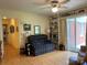 Cozy den with hardwood floors, natural light, and comfortable seating at 506 Hearne Farm Rd, Mount Gilead, NC 27306