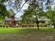 Charming brick home featuring a well-maintained lawn and mature landscaping at 506 Hearne Farm Rd, Mount Gilead, NC 27306