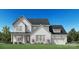 Charming two-story home featuring a brick-and-board facade, attached two-car garage, and manicured front lawn at 5337 Mint Harbor Way # 0302, Charlotte, NC 28269