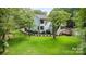 Large backyard with lush green grass, mature trees, and a home featuring a deck at 6639 Camp Creek Rd, Lancaster, SC 29720