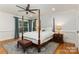 Elegant bedroom featuring a four-poster bed, hardwood floors, and natural light at 6639 Camp Creek Rd, Lancaster, SC 29720