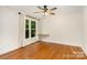 Cozy bedroom featuring hardwood floors, neutral paint, and a large window at 6639 Camp Creek Rd, Lancaster, SC 29720