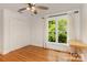 This bedroom has hardwood floors, a ceiling fan, a window with curtains, and a closet at 6639 Camp Creek Rd, Lancaster, SC 29720