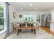 Bright dining room with modern furnishings, a wooden table, and bench seating at 6639 Camp Creek Rd, Lancaster, SC 29720