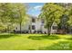 Charming two-story white home with a well-manicured lawn and mature trees creating a serene setting at 6639 Camp Creek Rd, Lancaster, SC 29720