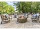 Stone patio area with comfortable seating surrounding a firepit, great for outdoor gatherings at 6639 Camp Creek Rd, Lancaster, SC 29720