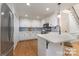 Bright kitchen with white cabinets, stainless steel appliances, an island, and hardwood floors at 6639 Camp Creek Rd, Lancaster, SC 29720