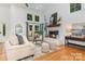 Elegant living room with a white brick fireplace, hardwood floors, and neutral furnishings at 6639 Camp Creek Rd, Lancaster, SC 29720