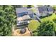 Aerial view of a home with a covered patio, trampoline, shed, and well-maintained yard at 6930 Culloden More Ct, Charlotte, NC 28217