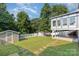 Lush backyard with a storage shed, trampoline, and covered patio, ideal for outdoor enjoyment at 6930 Culloden More Ct, Charlotte, NC 28217