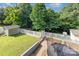Well-maintained backyard with a trampoline, shed, white picket fence, and mature trees at 6930 Culloden More Ct, Charlotte, NC 28217