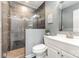 Modern bathroom featuring a glass enclosed shower with decorative tile and a white vanity with a large mirror at 6930 Culloden More Ct, Charlotte, NC 28217