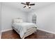 Relaxing bedroom features a comfortable bed, hardwood floors, and window at 6930 Culloden More Ct, Charlotte, NC 28217