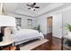 Spacious bedroom featuring a tray ceiling, hardwood floors, and neutral paint at 6930 Culloden More Ct, Charlotte, NC 28217