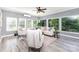 Light-filled living room features large windows overlooking the trees and comfortable seating at 6930 Culloden More Ct, Charlotte, NC 28217