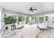 Bright living room features large windows, ceiling fan, and neutral decor with plenty of seating at 6930 Culloden More Ct, Charlotte, NC 28217