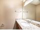 Bathroom vanity with granite counters, sink, faucet, mirror, and towel racks at 709 21St Ne Ave, Hickory, NC 28601
