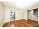 Open dining space displays wood floors, modern light fixture, and access to the kitchen and staircase at 709 21St Ne Ave, Hickory, NC 28601