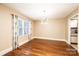 Sunlit dining room with hardwood floors, modern chandelier, and window, providing a pleasant atmosphere at 709 21St Ne Ave, Hickory, NC 28601