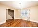 Well-lit dining room highlights hardwood flooring, a modern chandelier, and natural light from a window at 709 21St Ne Ave, Hickory, NC 28601