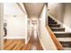 Bright hallway features hardwood floors, staircase, and doorways leading to other rooms in the home at 709 21St Ne Ave, Hickory, NC 28601