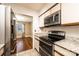 Tastefully kitchen featuring stainless appliances, granite countertops, an opening to the dinning area at 709 21St Ne Ave, Hickory, NC 28601