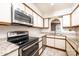 Modern kitchen boasts stainless steel appliances, granite countertops, and white cabinetry with stylish hardware at 709 21St Ne Ave, Hickory, NC 28601