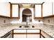 Close up of kitchen sink shows granite countertops, and neutral color scheme at 709 21St Ne Ave, Hickory, NC 28601
