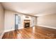 Inviting living room featuring a cozy fireplace with wood mantle and gleaming hardwood floors at 709 21St Ne Ave, Hickory, NC 28601