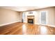 Bright living room featuring a cozy fireplace, gleaming hardwood floors, and a glass paneled door at 709 21St Ne Ave, Hickory, NC 28601