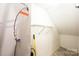 A small unfinished room has storage shelves and utility box at 709 21St Ne Ave, Hickory, NC 28601