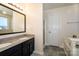 Bathroom vanity with granite countertops, dual sinks, and a large framed mirror at 8351 Rolling Meadows Ln, Huntersville, NC 28078