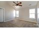 A bedroom with vaulted ceilings, two windows, neutral walls, and a ceiling fan at 8351 Rolling Meadows Ln, Huntersville, NC 28078