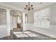 Dining room showcasing hardwood floors, decorative columns, chandelier and a large window at 8351 Rolling Meadows Ln, Huntersville, NC 28078