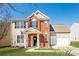 Charming two-story home with a brick facade, well-manicured lawn and American flag at 8351 Rolling Meadows Ln, Huntersville, NC 28078