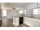 Well-lit kitchen with granite countertops, white cabinets, hardwood floors and stainless steel refrigerator at 8351 Rolling Meadows Ln, Huntersville, NC 28078