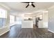 Open floorplan featuring hardwood floors, living room, dining area and adjacent kitchen at 8351 Rolling Meadows Ln, Huntersville, NC 28078