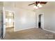 Spacious main bedroom featuring neutral carpet and two entry doors at 8351 Rolling Meadows Ln, Huntersville, NC 28078