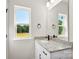 Bright bathroom features a granite countertop vanity, modern fixtures, and a large window at 1019 S Main St, Granite Quarry, NC 28146