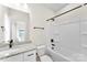 Bathroom with granite countertop vanity and white tiling in the tub and shower area at 1019 S Main St, Granite Quarry, NC 28146