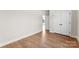 Bedroom with wood-look flooring, white walls, white trim, and a closet with double doors at 1019 S Main St, Granite Quarry, NC 28146