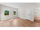 Bright bedroom features two windows, wood-look flooring, neutral walls, and white trim at 1019 S Main St, Granite Quarry, NC 28146