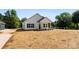 New white farmhouse with black trim and front porch showcases modern design and curb appeal at 1019 S Main St, Granite Quarry, NC 28146