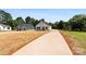 Newly constructed white farmhouse-style home with modern design and a long driveway leading to the property at 1019 S Main St, Granite Quarry, NC 28146