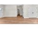 Open living space featuring wood-look flooring, neutral wall colors, and hallway access at 1019 S Main St, Granite Quarry, NC 28146