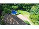 Aerial view of a beautiful home with a pool, carport, and ample yard space surrounded by lush greenery at 12101 Ranburne Rd, Mint Hill, NC 28227