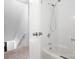 Bathroom with a shower-tub combo featuring white tiling and modern fixtures at 12101 Ranburne Rd, Mint Hill, NC 28227